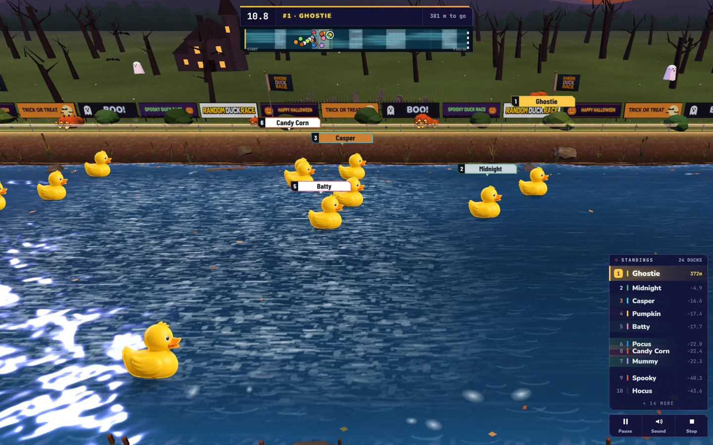 Random Duck Race screenshot, a Halloween race: The Halloween scenery: bare trees, jack-o’-lanterns, a graveyard and a haunted house under a violet sky, ghosts and bats over the far bank (Settings › Scenery).